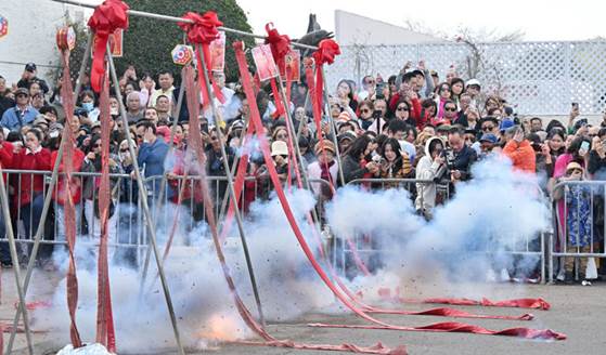 Visitors at the Asian Gardens 2025 Lunar New Year Firecracker Show watch the explosions in Westminster, CA, on Wednesday, Jan. 29, 2025. The Lunar New Year party had firecrackers, music, and a lion dance to celebrate the Year of the Snake.