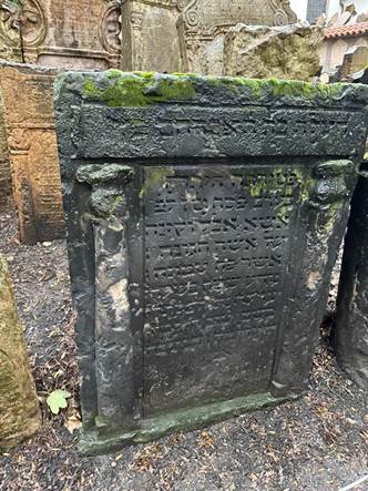 A stone tombstone with writing on it

AI-generated content may be incorrect.